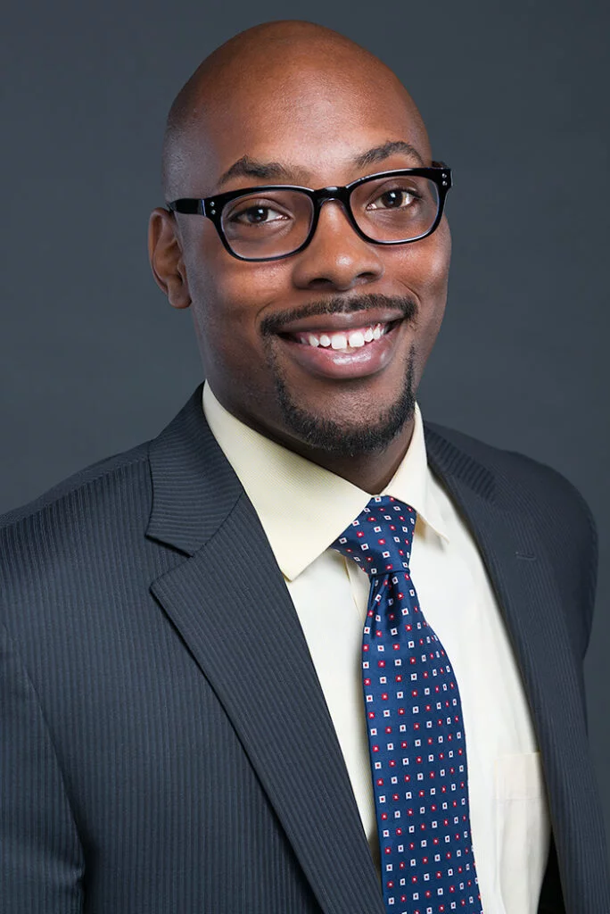 Professional headshot of man wearing glasses