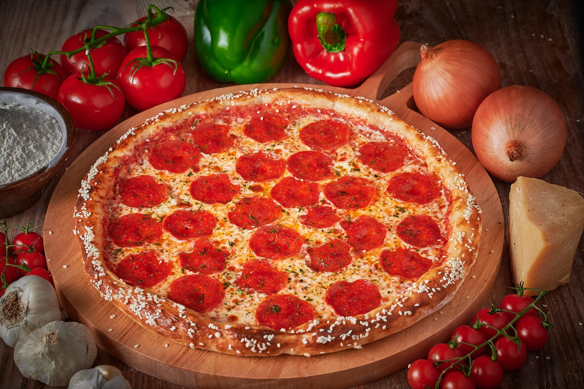 Photograph of a delectable Pepperoni Pizza artfully surrounded by a medley of fresh vegetables, skillfully captured in food photography.