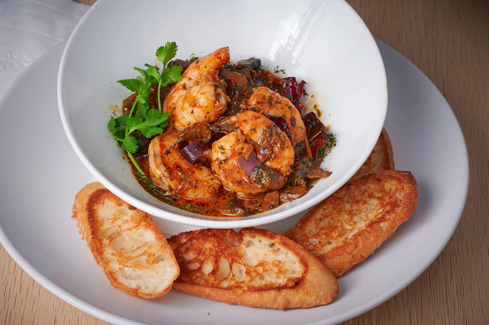Photograph of Guajillo Shrimp with Toast, a mouthwatering dish expertly captured in food photography.
