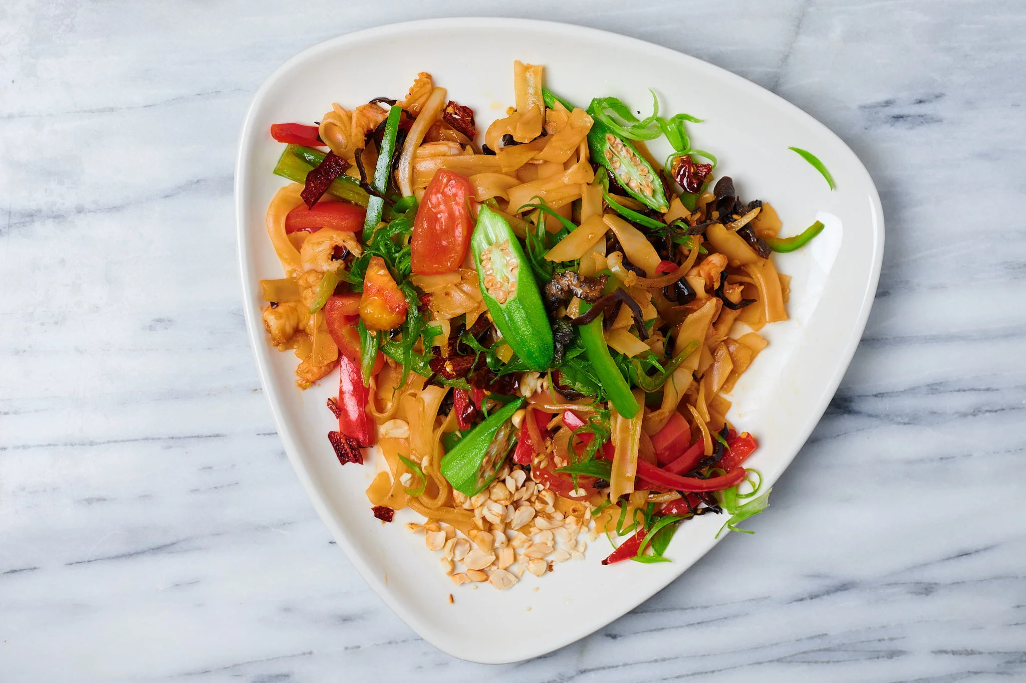 Vibrantly photographed stir-fry vegetables on a white plate