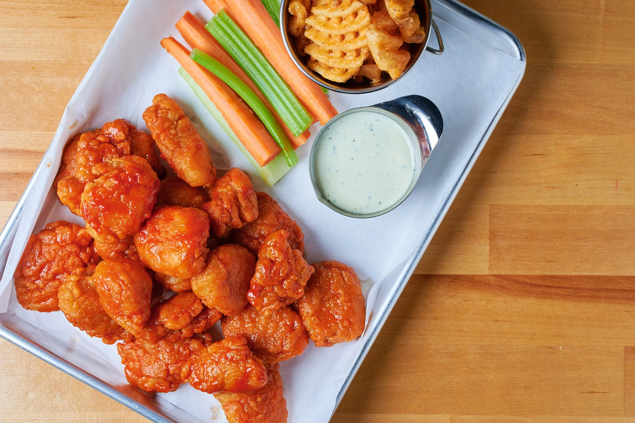 Boneless Wings: Tender, bite-sized pieces of chicken, breaded and fried to perfection, served with a variety of flavorful dipping sauces.
